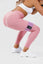 Close up of girl squatting in pink adapt scrunch bum leggings wearing purple resistance bands around thighs