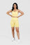Girl posing hand on hips wearing yellow calypso seamless set