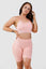 Girl posing wearing pink calypso seamless sport bra front