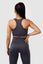 Girl wearing invictus seamless set in charcoal, hand on hip, back