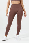 Girl wearing invictus seamless leggings mauve purple front 