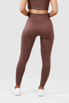 Girl wearing invictus seamless leggings mauve purple front 