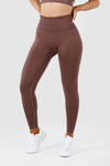 Girl wearing invictus seamless leggings mauve purple front 