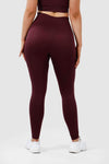 girl wearing invictus seamless leggings in plum purple front