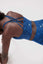 Girl wearing blue legacy sports bra doing push up