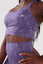 close up girl wearing legacy sports bra purple hand on hip