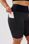 Girl wearing black luna bike shorts hands in pockets