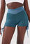 Close up girl wearing blue luna scrunch bum shorts front