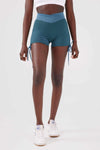 Close up girl wearing blue luna scrunch bum shorts front