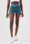 Girl wearing blue luna scrunch bum shorts front
