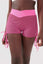 Close up girl wearing pink luna scrunch bum shorts front