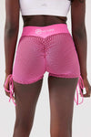 Close up girl wearing pink luna scrunch bum shorts front