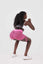 girl squatting wearing pink luna scrunch bum shorts