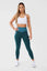 Girl posing hand on hip wearing blue luna scrunch bum leggings
