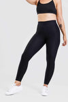 Girl posing wearing adapt scrunch bum leggings in black, front shot