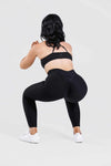 Girl posing wearing adapt scrunch bum leggings in black, front shot