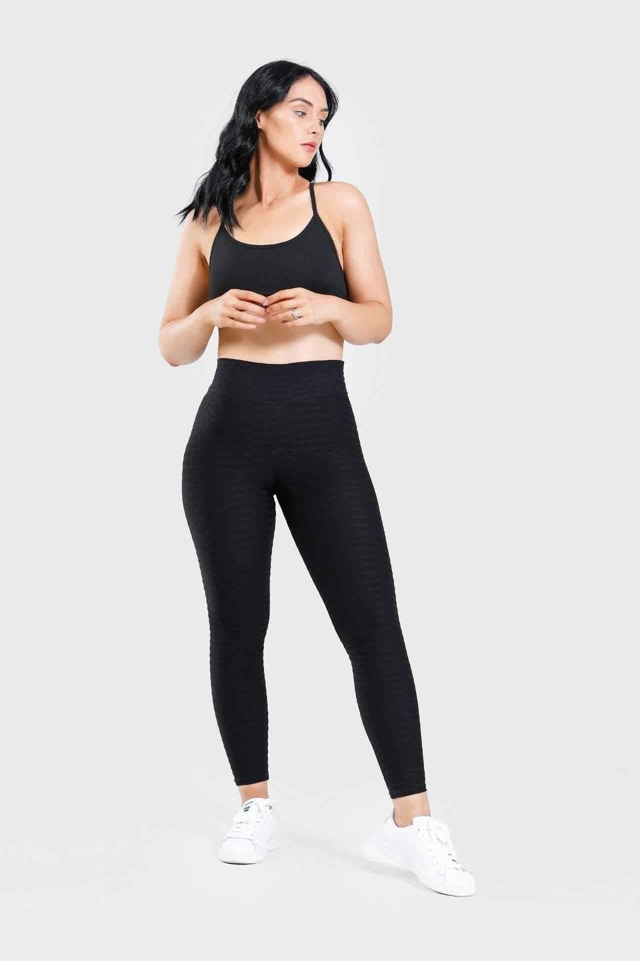 Girl wearing adapt scrunch bum leggings in black
