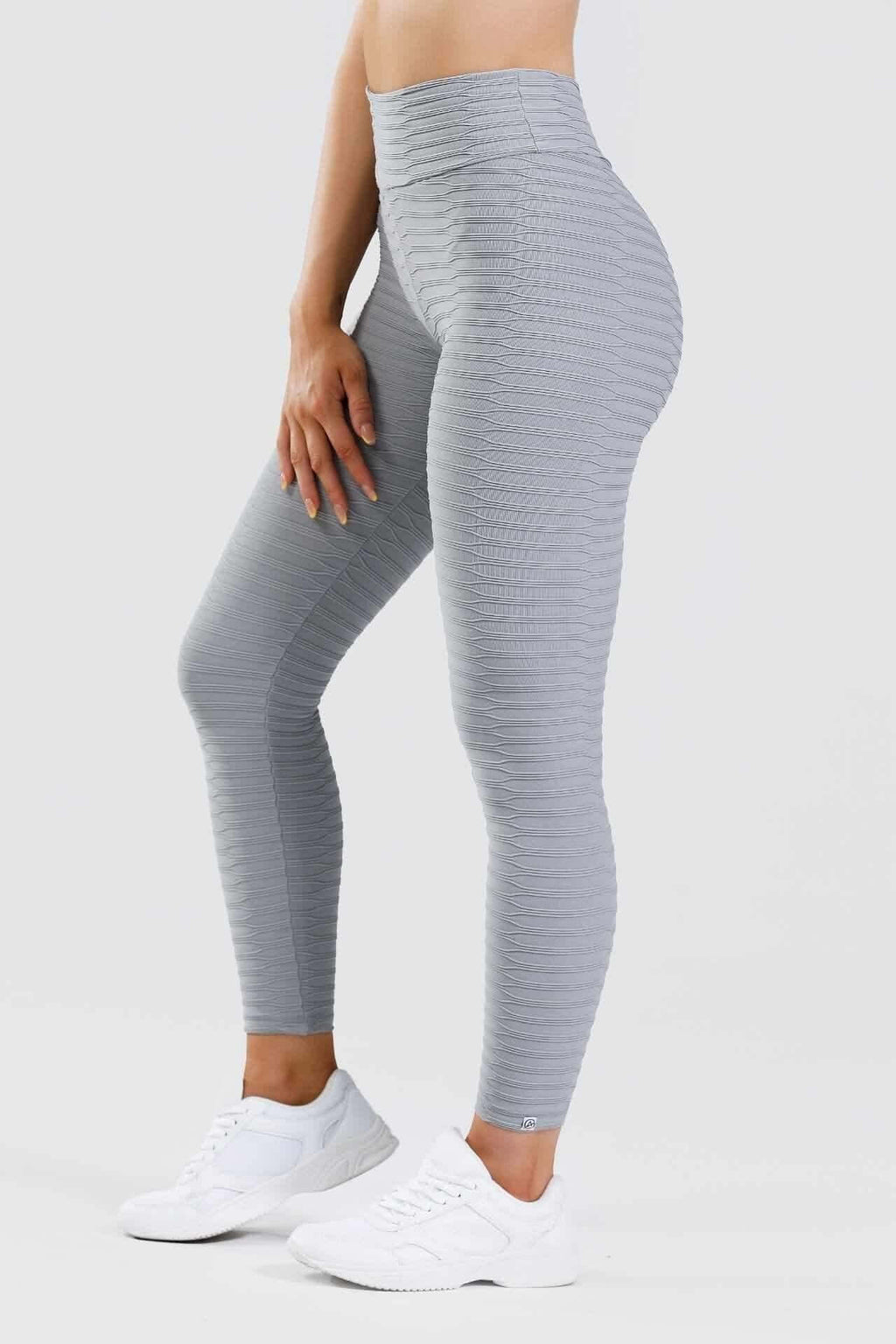 Side view of girl wearing grey adapt scrunch bum leggings in grey