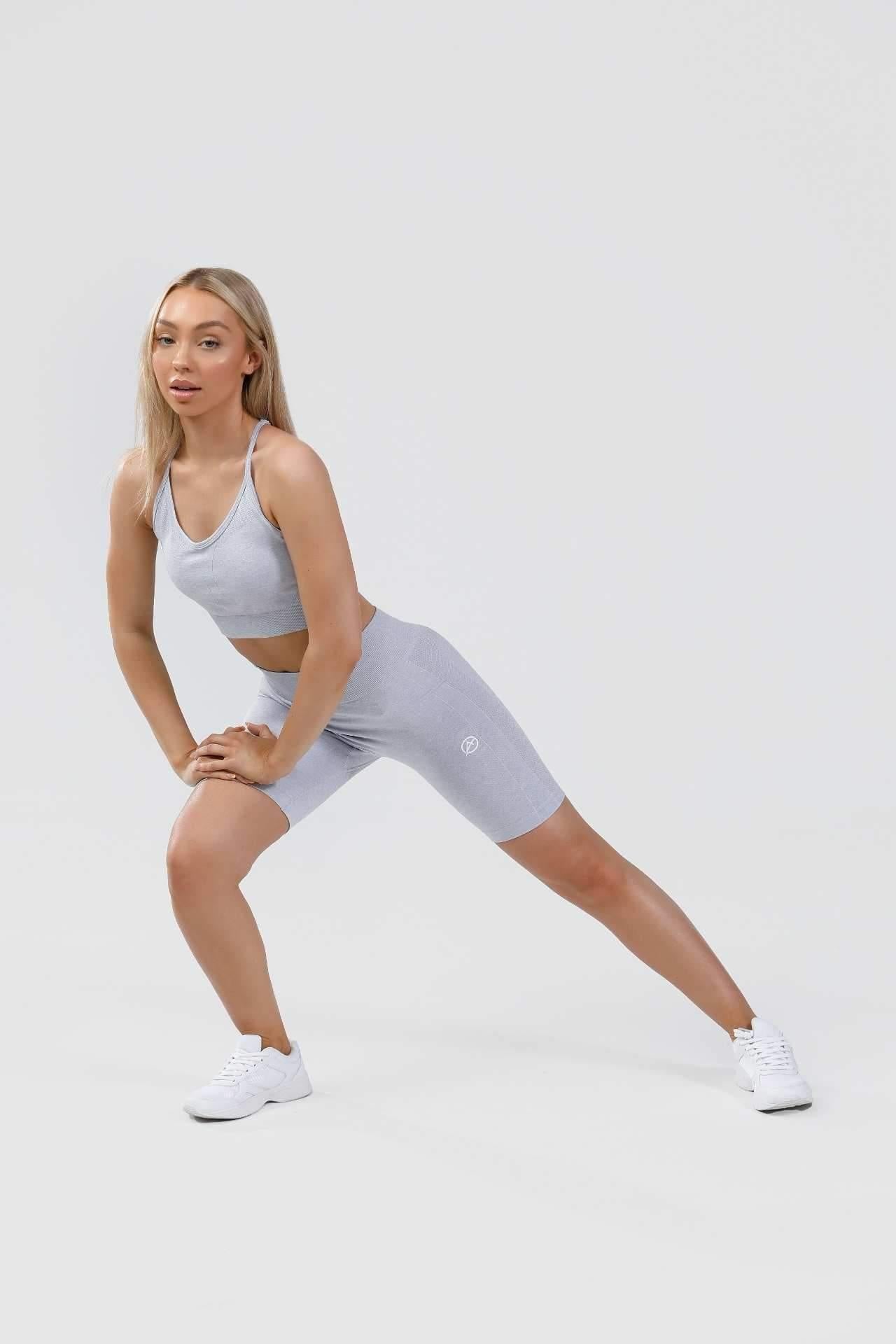 Girl lunging to the side wearing calypso seamless set in blue marl