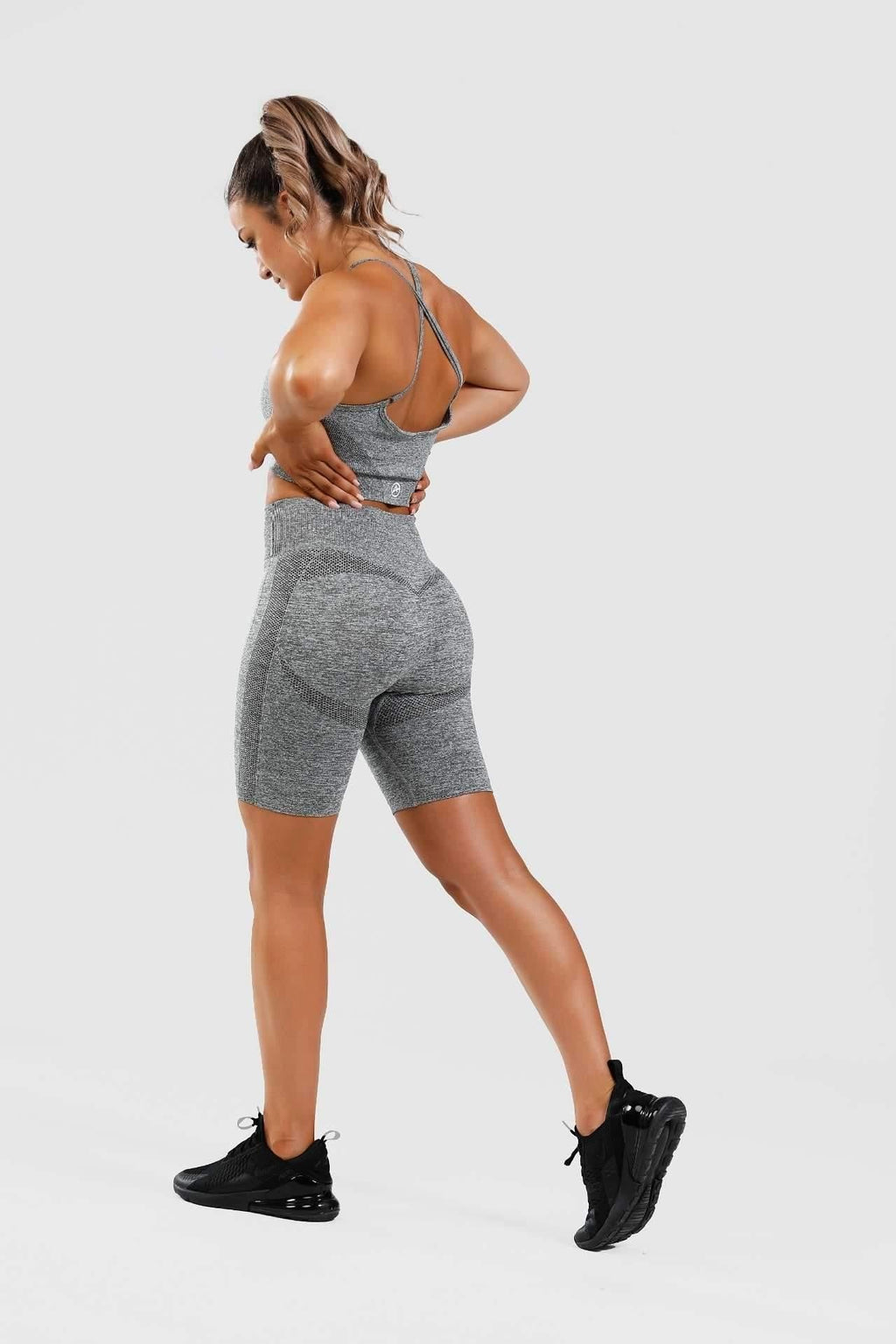 Side shot of girl wearing calypso seamless set in grey 