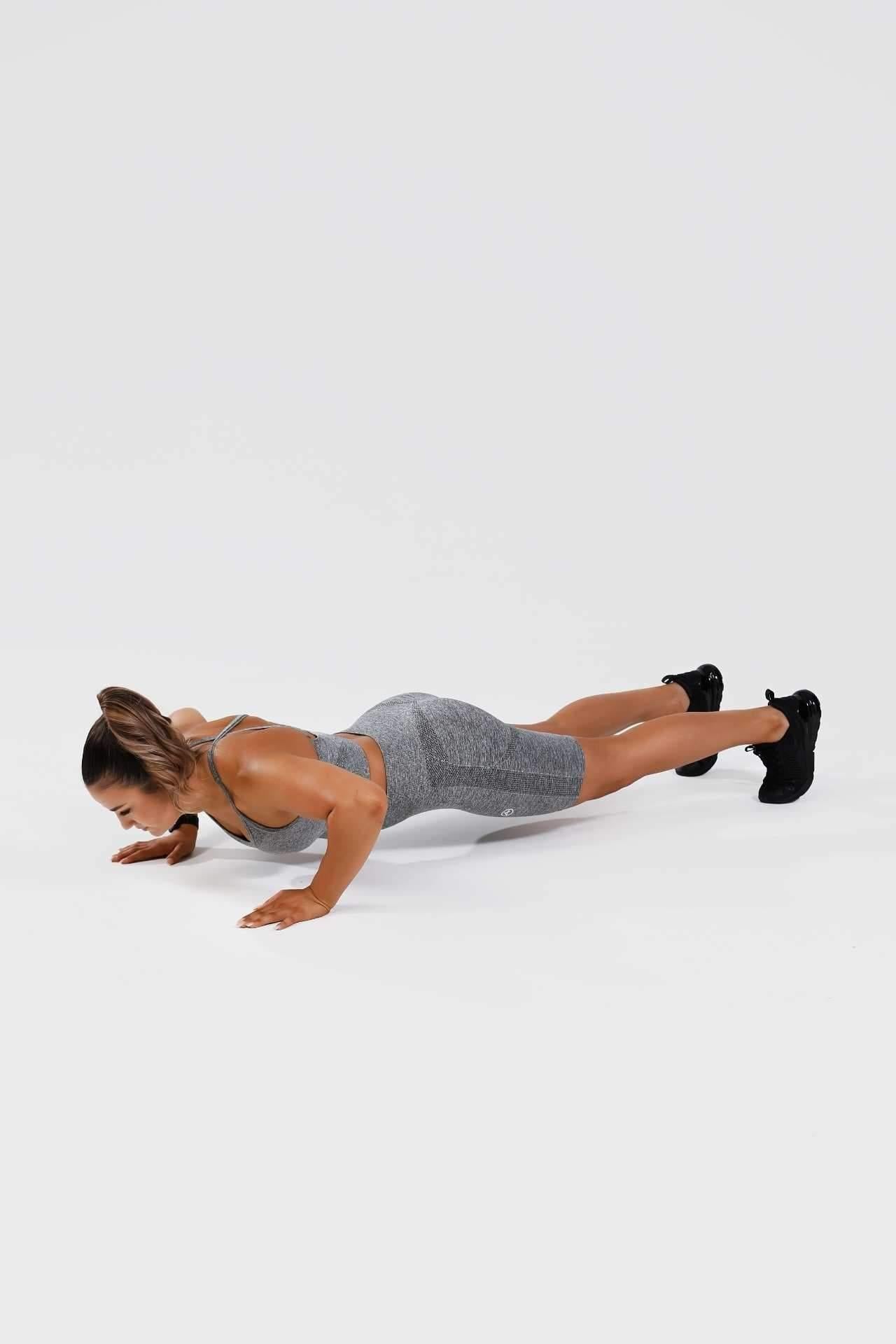 Girl holding push up wearing grey calypso seamless set