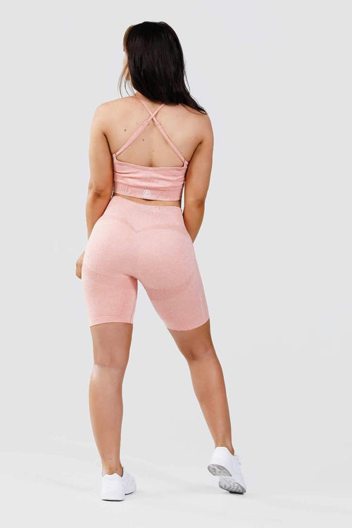Girl wearing calypso seamless set in pink marl from behind 
