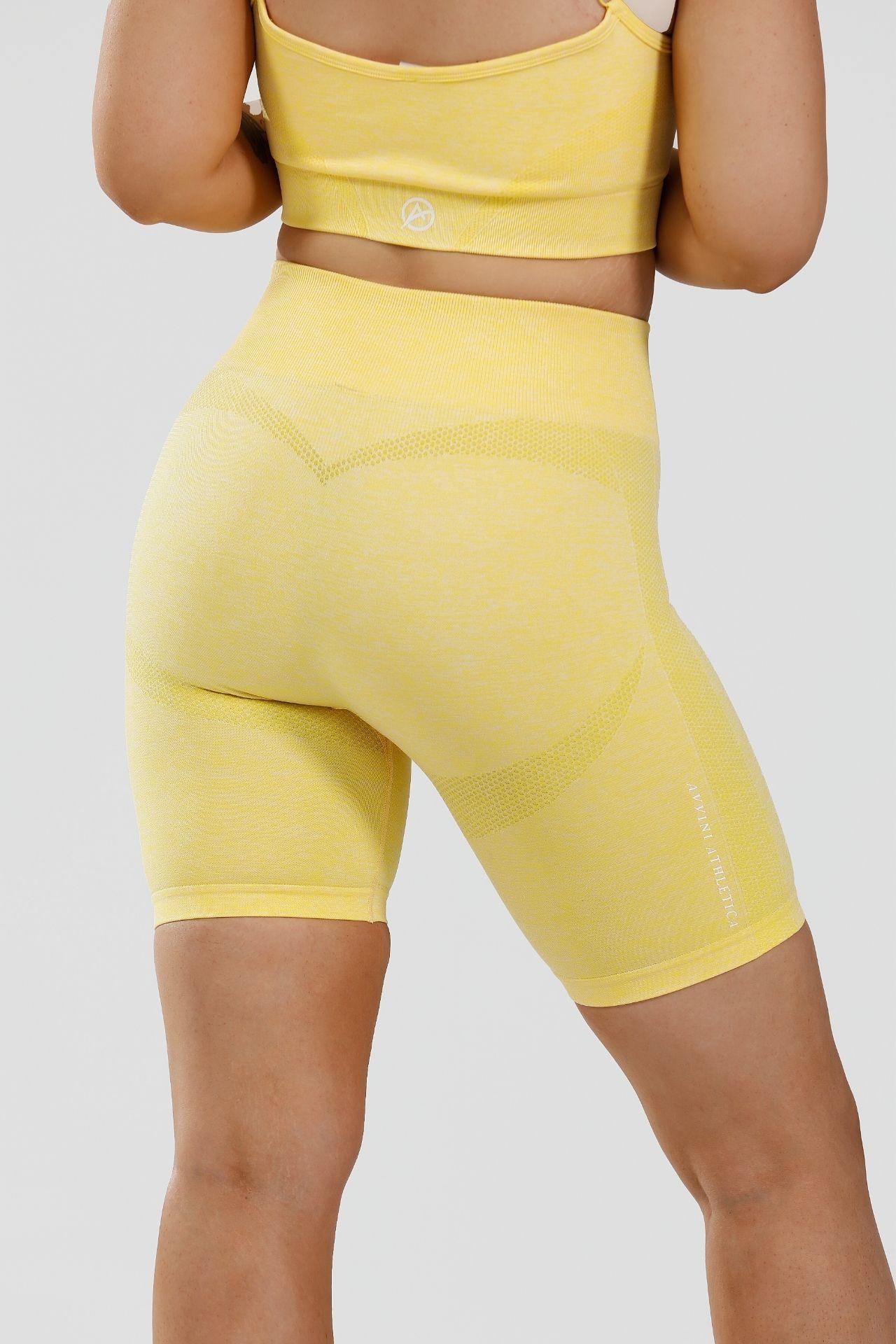 Close up girl wearing yellow calypso seamless shorts back