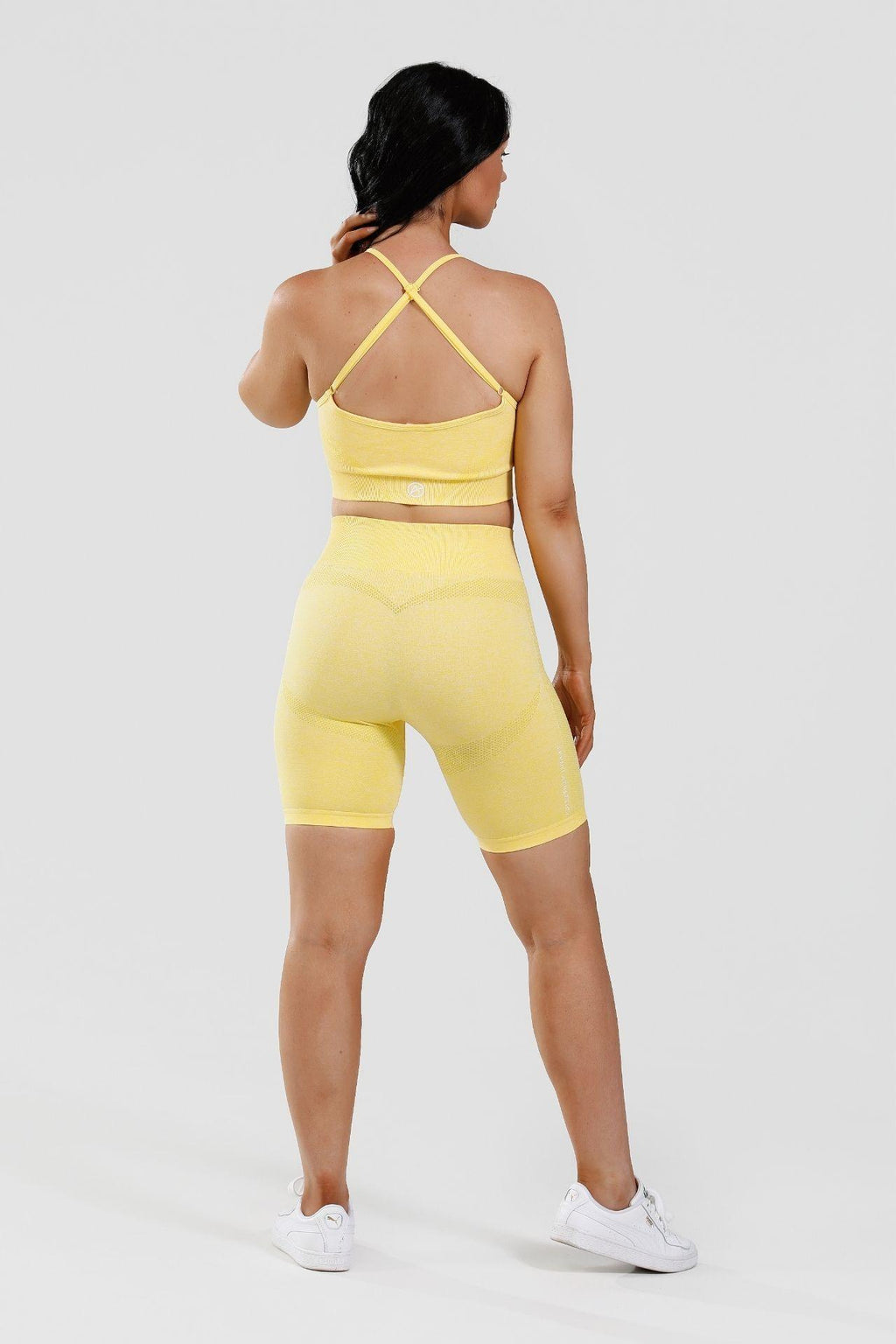 Girl wearing yellow calypso seamless set from behind 