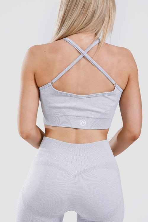 Close up girl wearing calypso seamless sports bra in blue marl from behind 