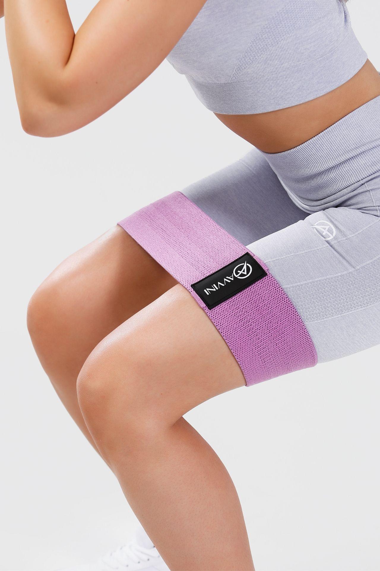 Close up purple resistance band around thighs