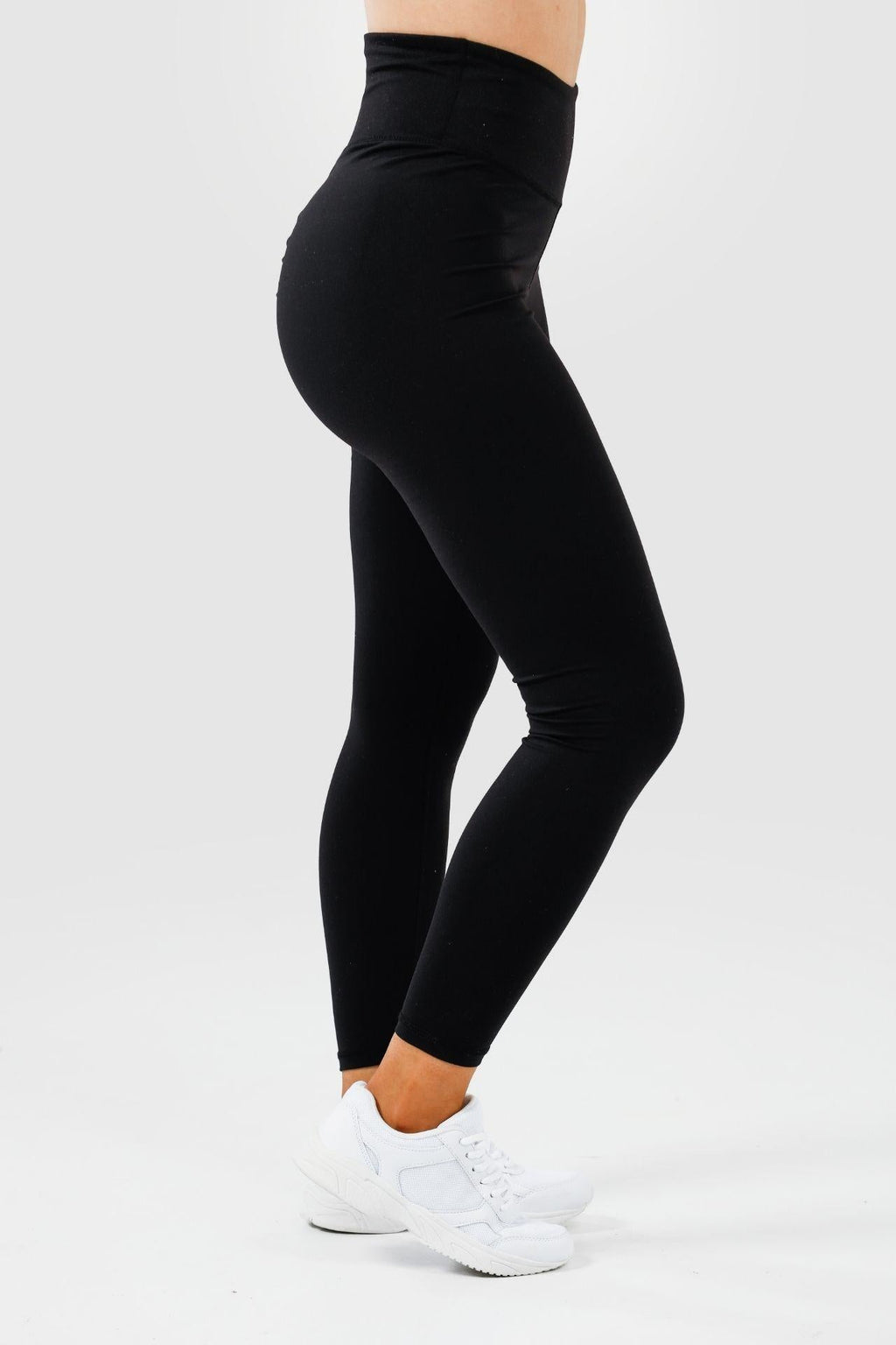 Side view of girl wearing black intrigue scrunch bum leggings