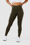 Girl wearing olive intrigue scrunch bum leggings hands on hips