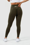 Girl wearing olive intrigue scrunch bum leggings hands on hips