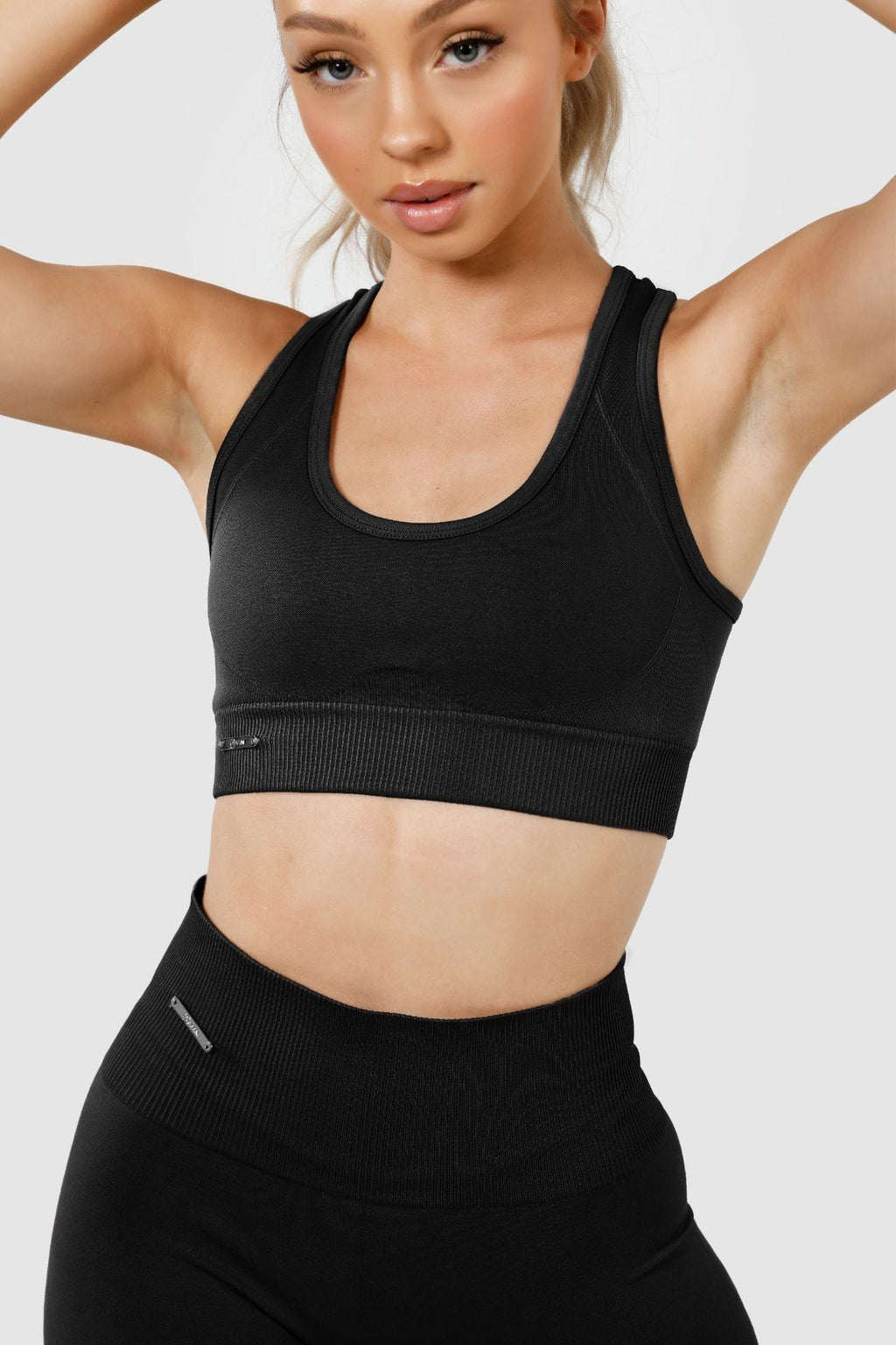 Close up girl wearing invctus seamless crop in black, front