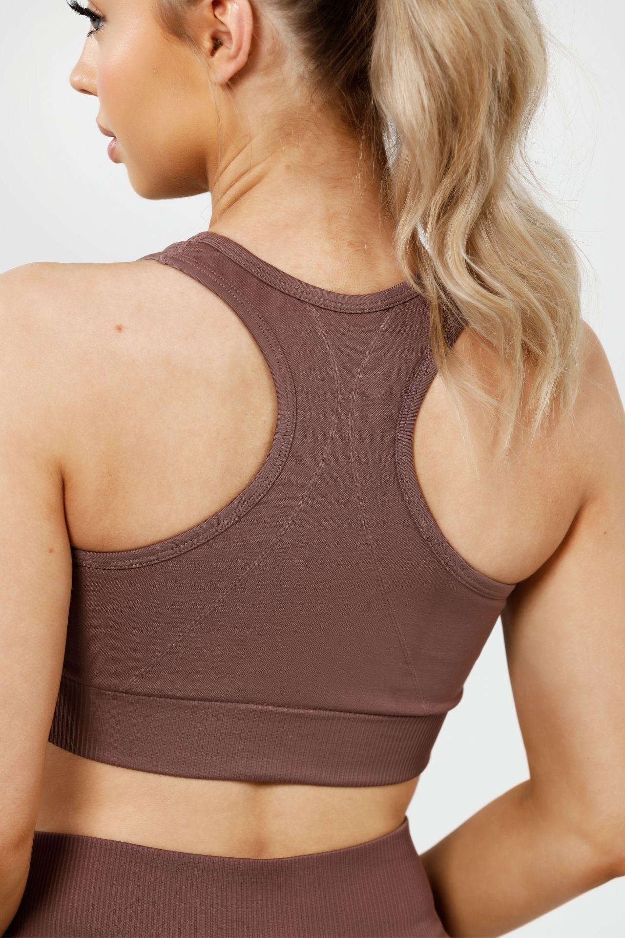 Girl wearing invictus seamless crop mauve purple, back