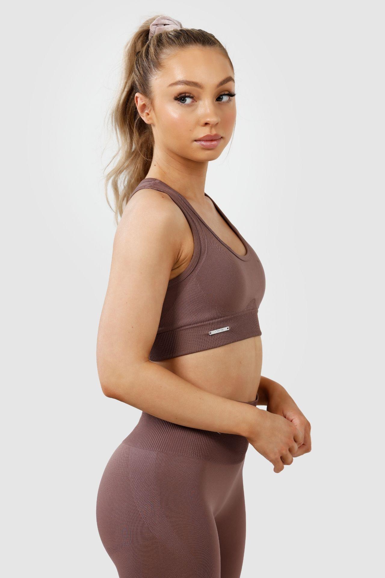 Girl wearing invictus seamless set in mauve purple side profile