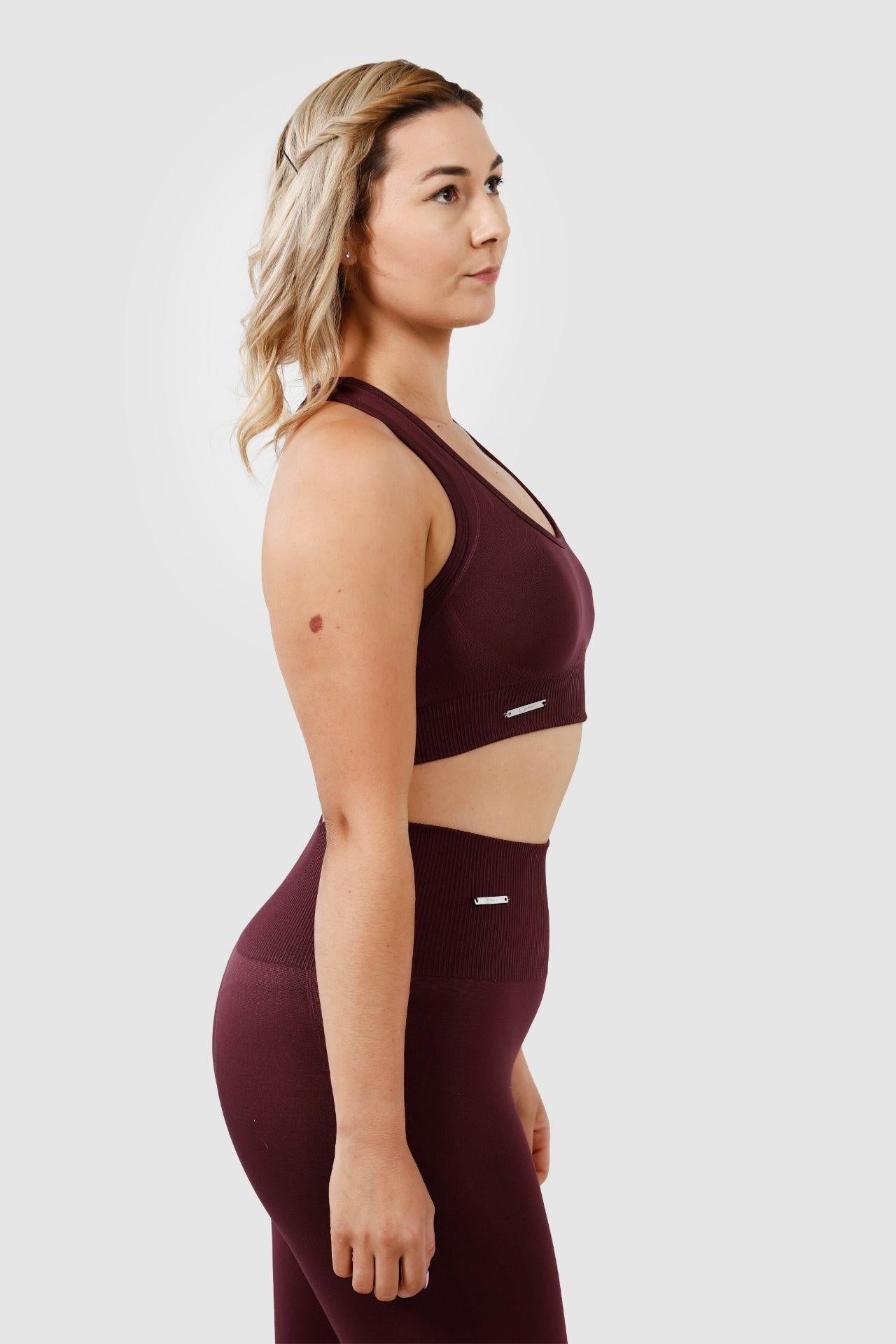 Girl wearing invictus seamless set in plum purple side view