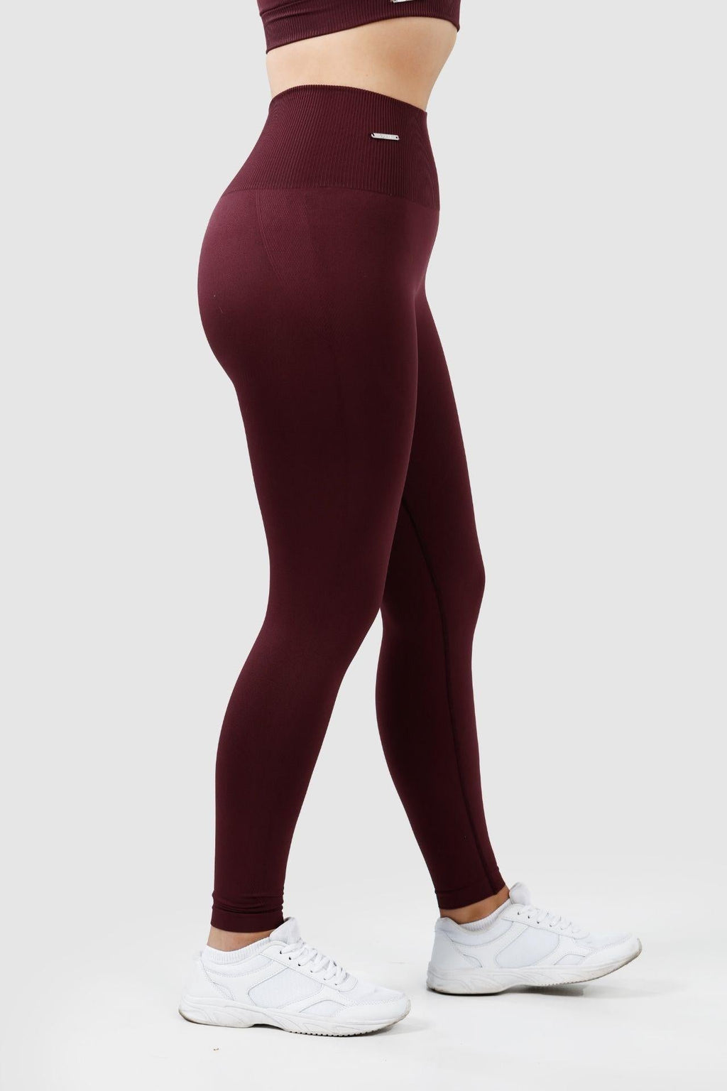 side view of girl wearing invictus seamless leggings in plum purple