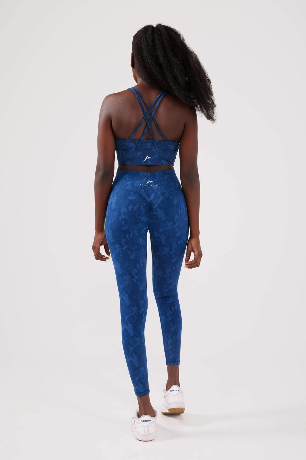 Girl wearing blue legacy scrunch bum set back