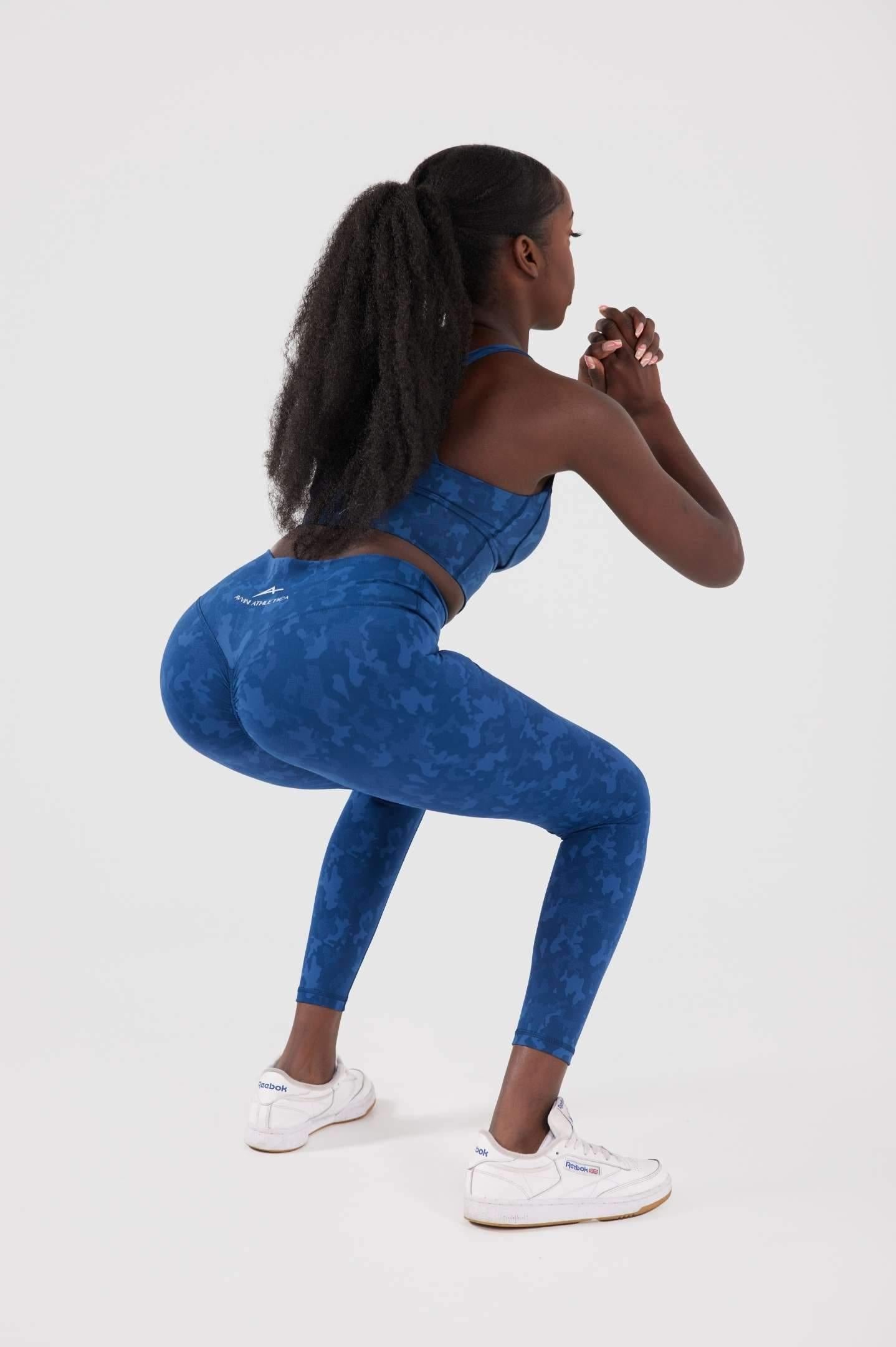Girl squatting in blue legacy scrunch bum set 