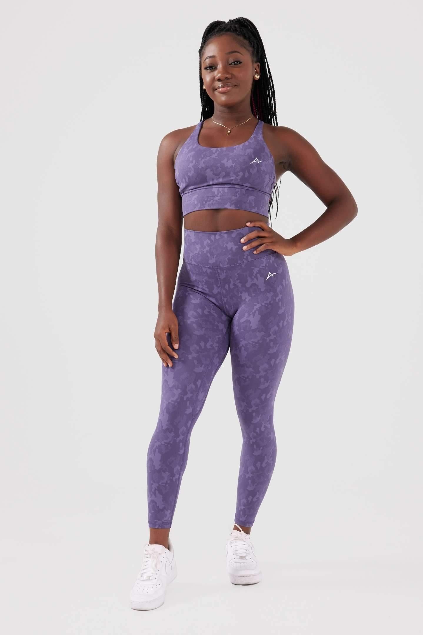Girl posing hand on hip wearing legacy scrunch bum set in purple front