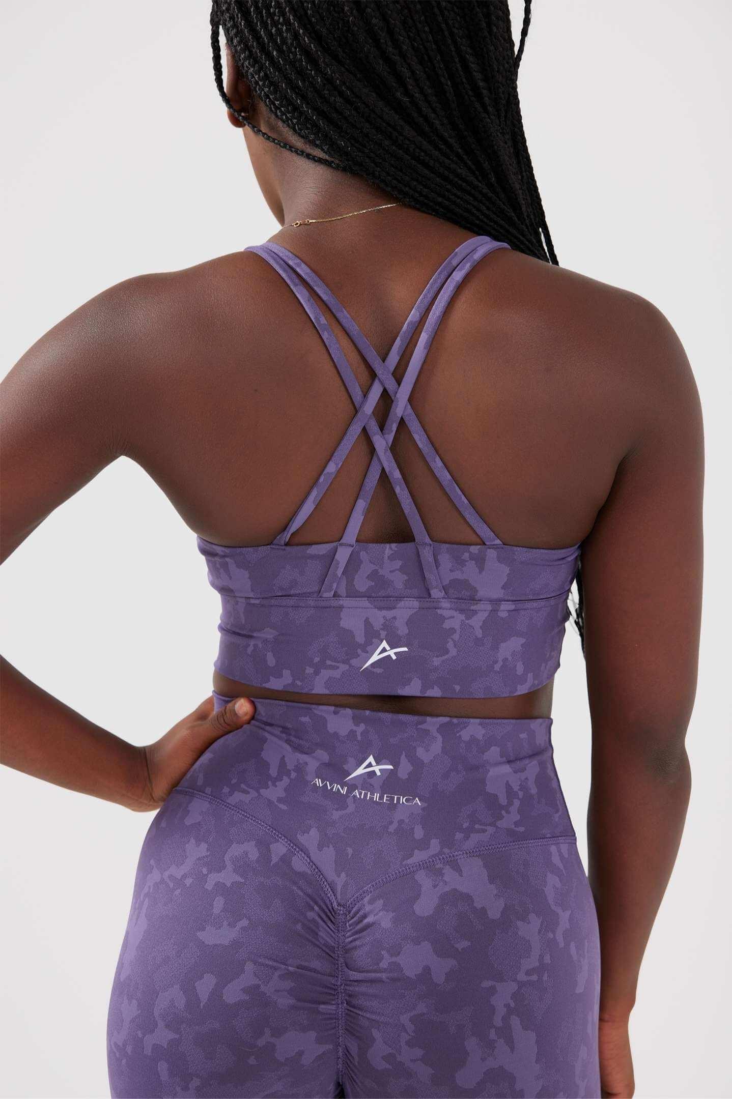 girl posing hand on hip wearing purple legacy scrunch bum set back