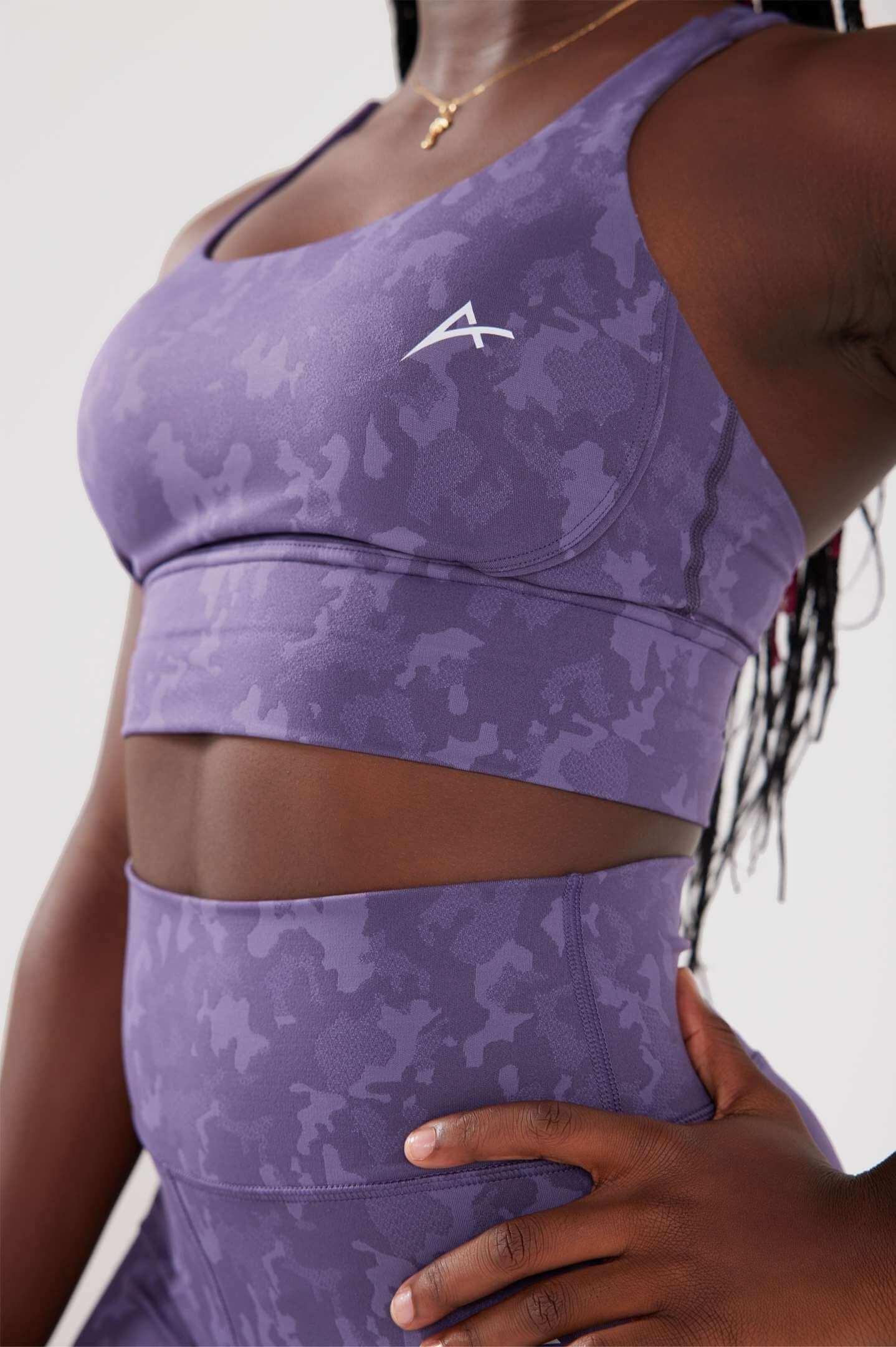 close up girl wearing legacy sports bra purple hand on hip
