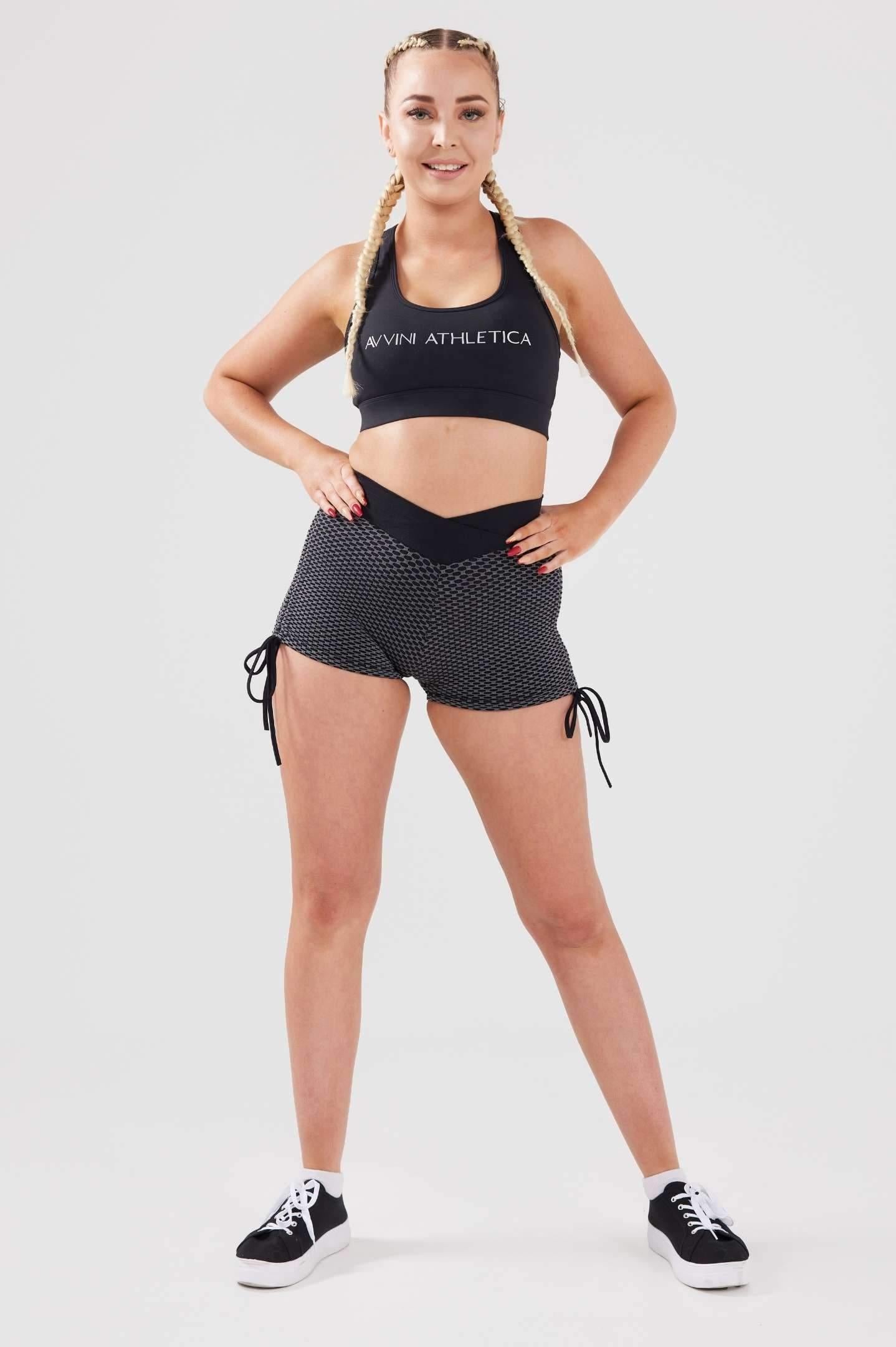 Girl posing hands on hips wearing luna scrunch bum shorts front