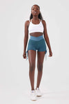 Close up girl wearing blue luna scrunch bum shorts front