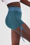 Close up girl wearing blue luna scrunch bum shorts front