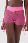 Close up girl wearing pink luna scrunch bum shorts front
