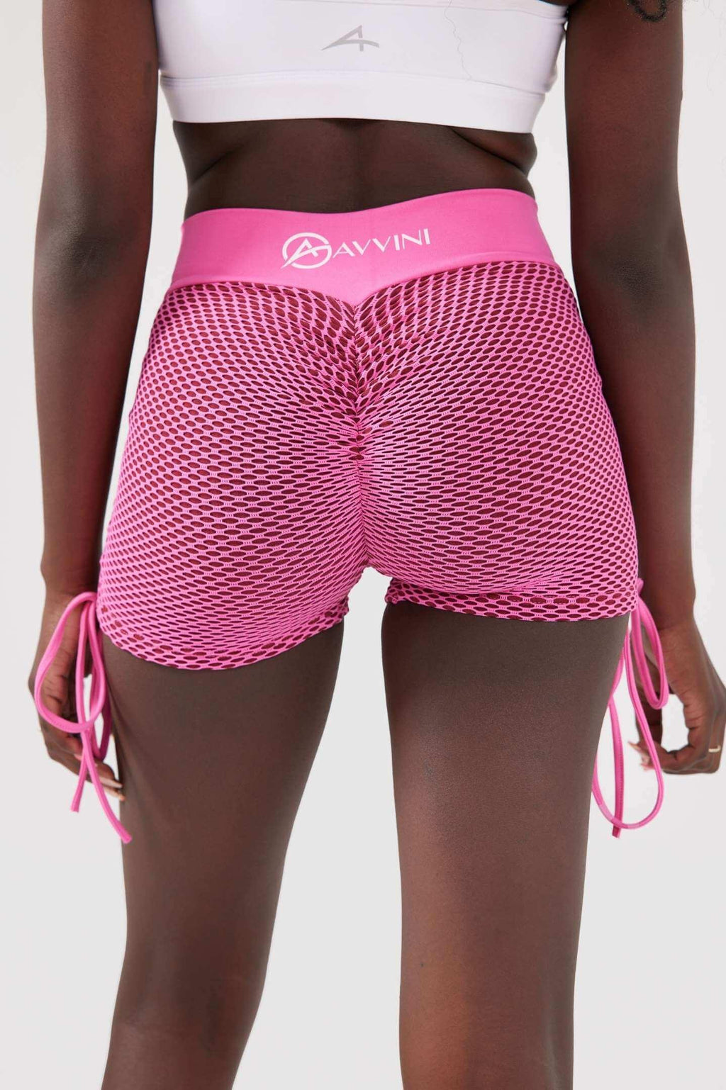 Girl weaing pink luna scrunch bum shorts back