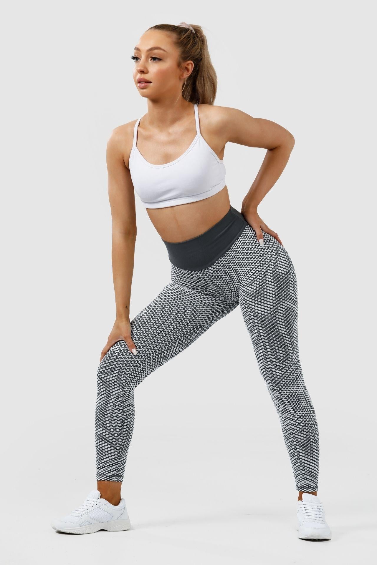 Girl posing hand on thigh and hip wearing grey scrunch bum leggings