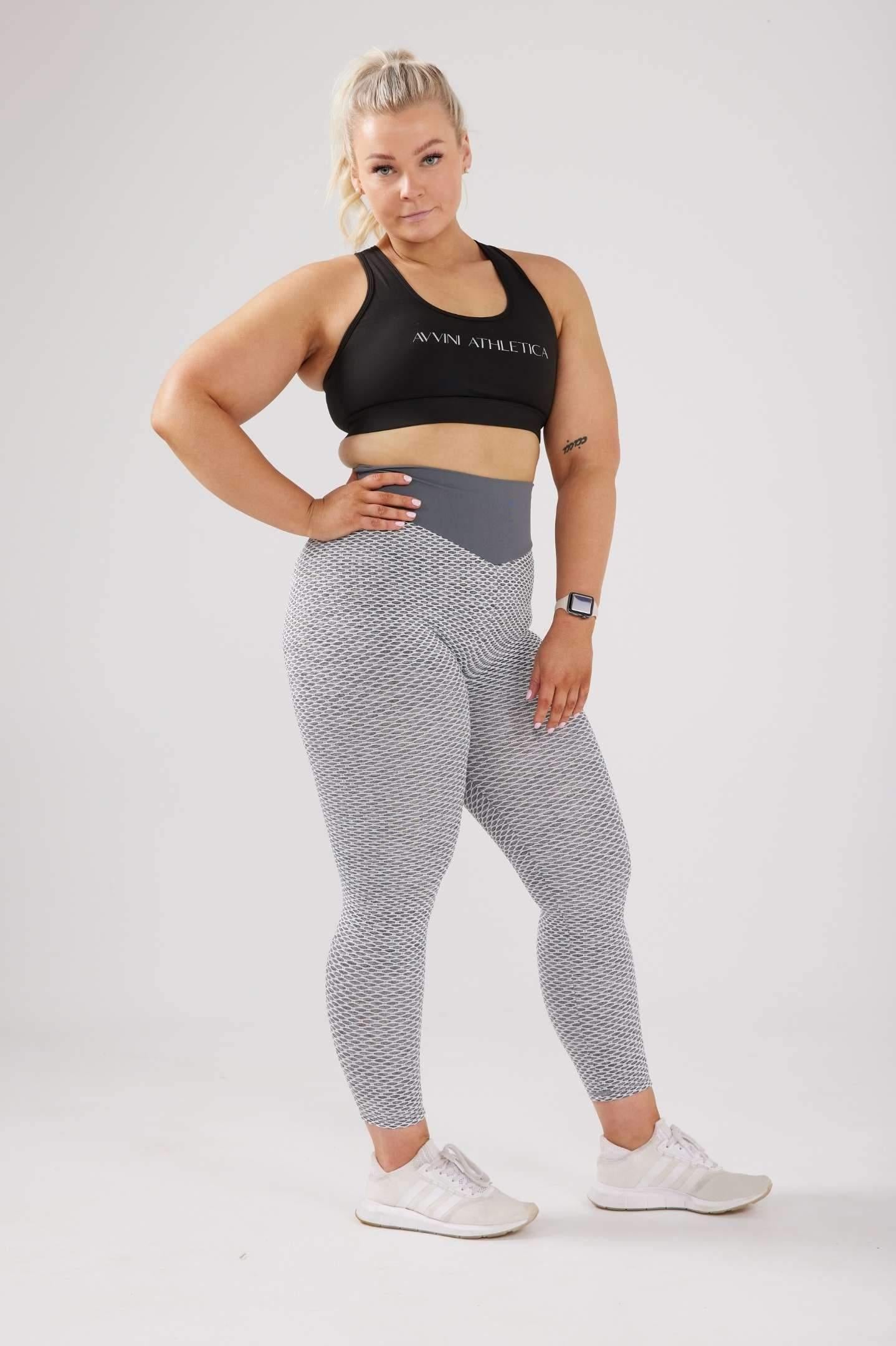 Girl posing hand on hip wearing large luna grey scrunch bum leggings with black crop top